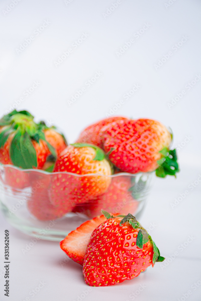 Red fresh strawberry in a bowl isolated on white background Red fresh strawberry in a bowl isolated on white background