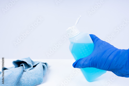 Putting disinfectant onto a cloth for cleaning