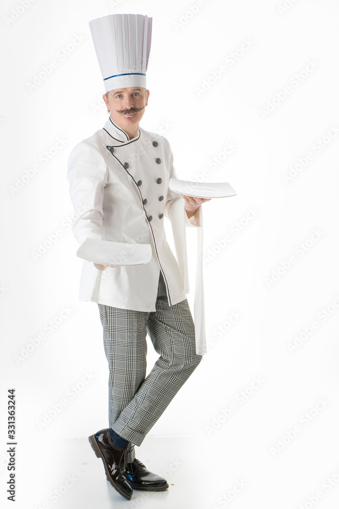 Elegant chef cook posing with a white plates on a white background Elegant chef cook posing with a white plates on a white background