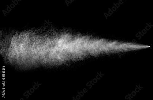 Spray stream from aerosol can on black background photo