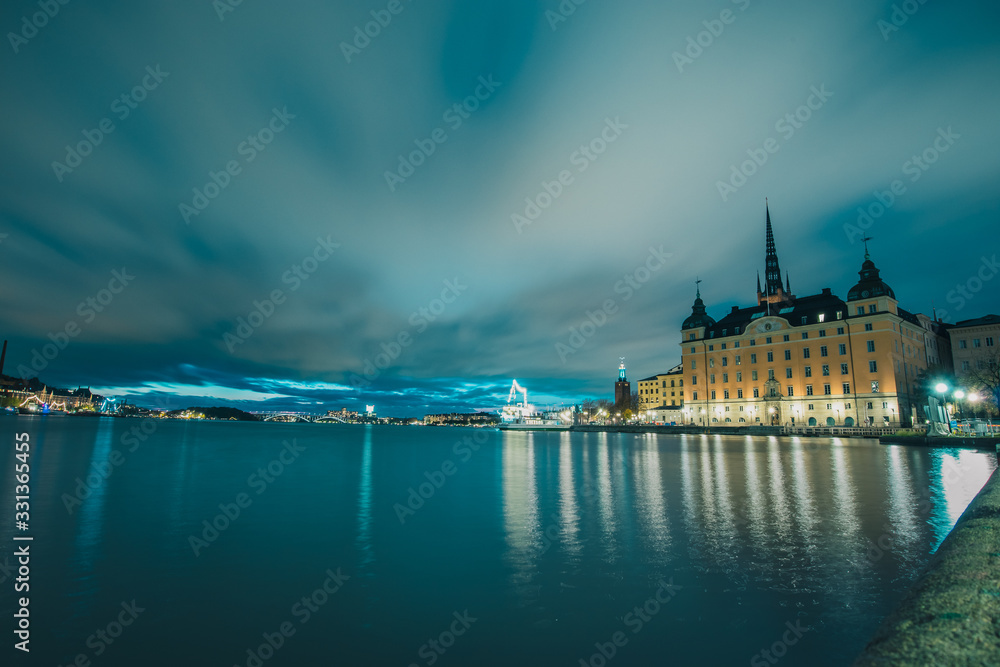 Long exposure of riddarholmen and gamla stan in Stockholm, Sweden during a cloudy romantic night in autumn.