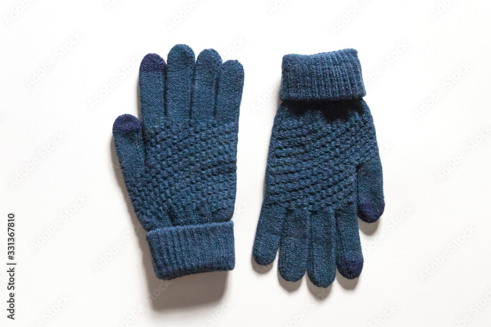 Dark blue knitted touch screen gloves isolated on white background. Dark blue knitted touch screen gloves isolated on white background.