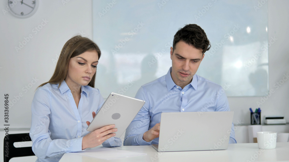 Sharing Opinions, Business Colleagues Using Tablet and Laptop During Work Sharing Opinions, Business Colleagues Using Tablet and Laptop During Work