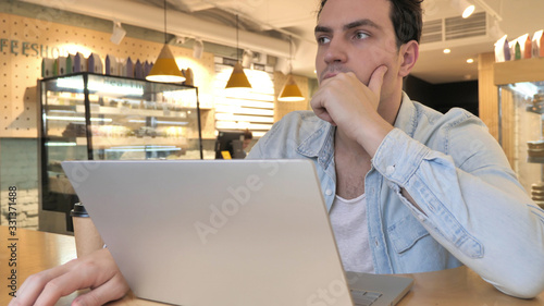 Wallpaper Mural Thinking, Brainstorming Young Man Working in Cafe Torontodigital.ca