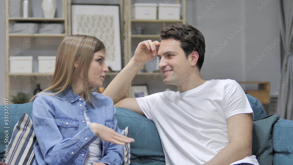 Talking Happy Couple Relaxing on Couch and Discussing Future Talking Happy Couple Relaxing on Couch and Discussing Future