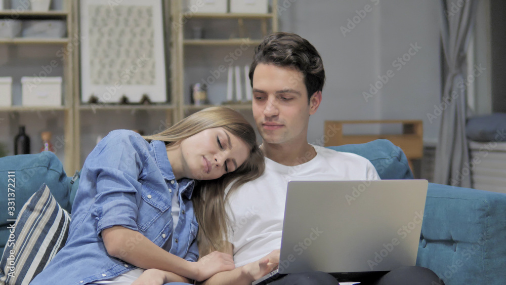 Happy Man Using Laptop while Sleeping Girlfriend Head on His Shoulder Happy Man Using Laptop while Sleeping Girlfriend Head on His Shoulder