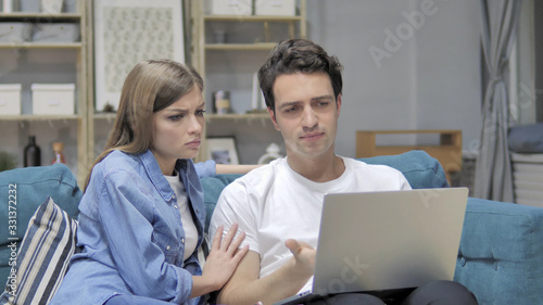 Frustrated Unhappy Young Couple Reacting to Loss on Laptop