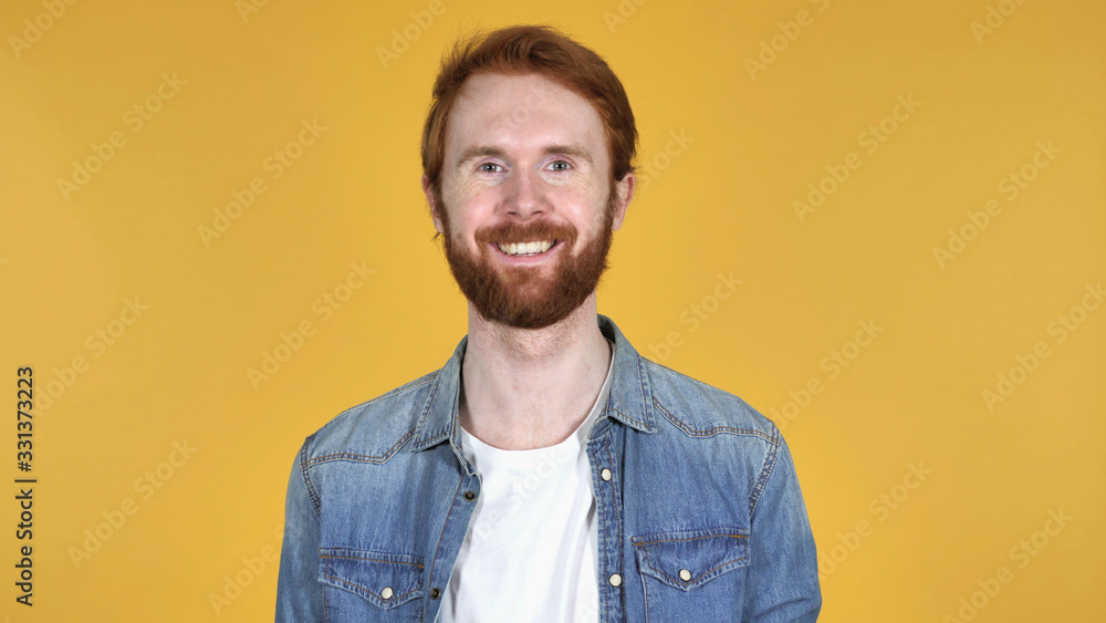 Smiling Redhead Man Isolated on Yellow Background Smiling Redhead Man Isolated on Yellow Background