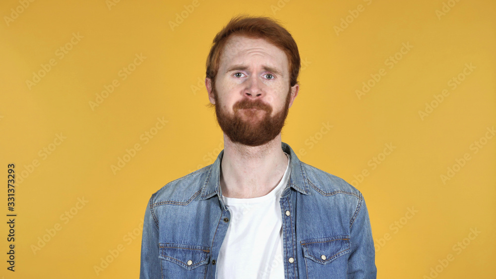 Obraz premium Redhead Man Shaking Head to Reject Isolated on Yellow Background