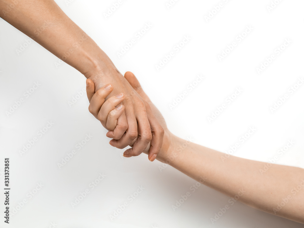 Two women 's hands in a handshake. Concept of business, friendship and support. The white background. Copyspace Two women 's hands in a handshake. Concept of business, friendship and support. The white background. Copyspace