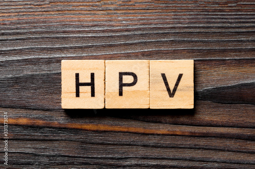 HPV word written on wood block. HPV text on wooden table for your desing, Top view concept photo