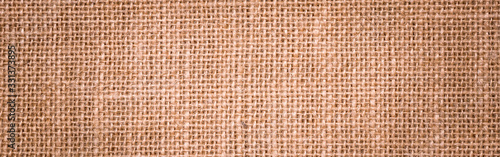 Rough hessian background with flecks of varying colors of beige and brown. with copy space. office desk concept  Hessian sackcloth burlap woven texture background.