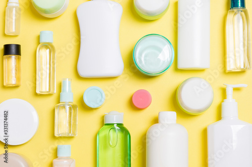 Group of plastic bodycare bottle Flat lay composition with cosmetic products on yellow background empty space for you design. Set of White Cosmetic containers, top view with copy space