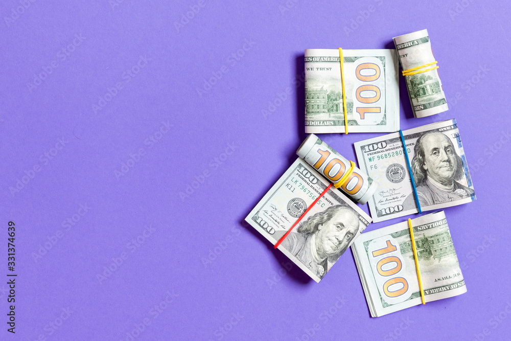 US Dollar bills bundles stack. one hundred dollar bills with stack of money in the middle. Top view of business concept on background with copy space