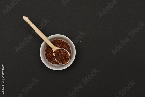 loose rooibos tea in a serving wooden spoon