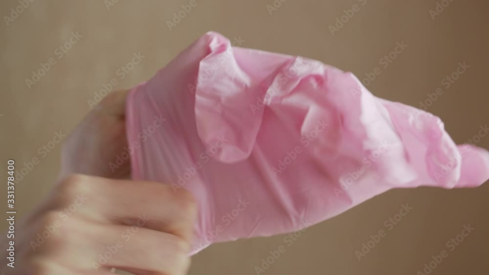 Putting on a nitrile glove on a hand. Close up Putting on a nitrile glove on a hand. Close up