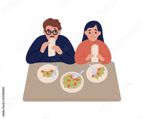 Hungry couple eat falafel in pita sit at table isolated on white background. Cartoon man and woman trying tasty shawarma at restaurant or cafe vector flat illustration. People chew delicious meal