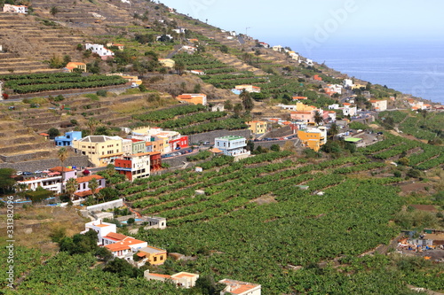 view to the village Hermigua on the Canary island La Gomera with multi colored houses and palm trees photo