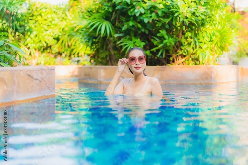 Portrait beautiful young asian woman relax around swimming pool in hotel resort © siraphol