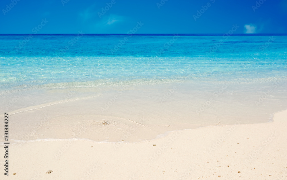 Ocean sand beach and blue sky as summer vacation concept
