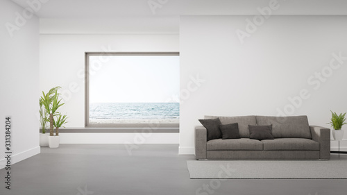 Sofa on concrete floor of large living room in modern house or luxury hotel. Minimal home interior 3d rendering with beach and sea view.