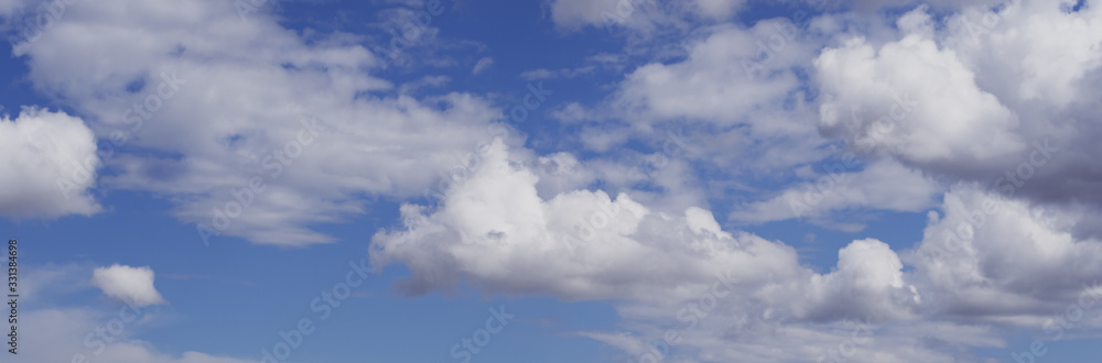 White fluffy clouds in blue sky. Panoramic view White fluffy clouds in blue sky. Panoramic view