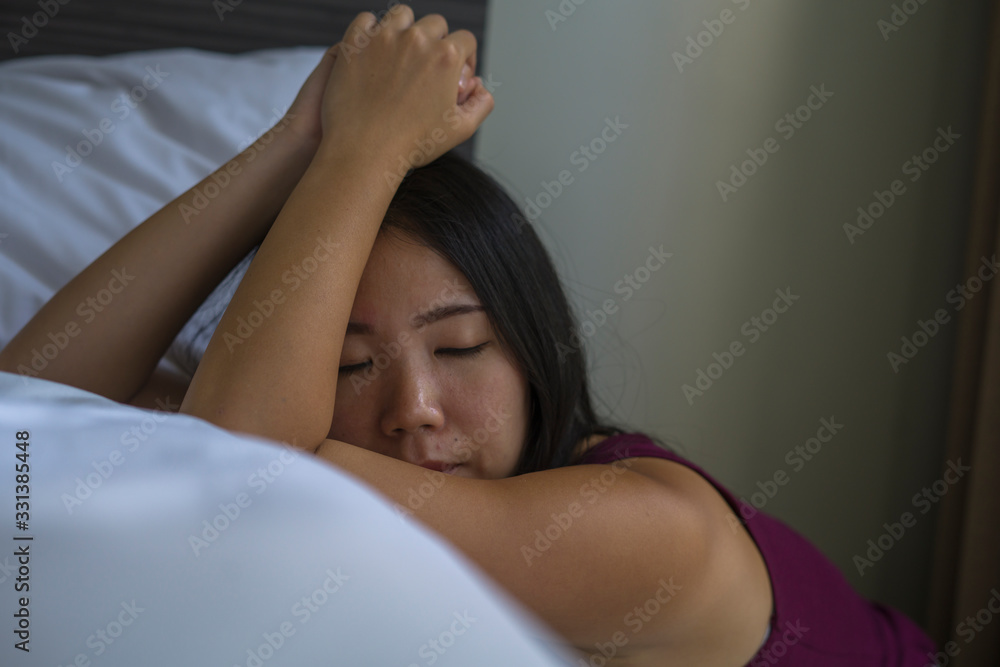 indoors portrait of young attractive sad and depressed Asian Korean woman at home on bedroom floor leaning on bed emotional and thoughtful feeling worried and scared indoors portrait of young attractive sad and depressed Asian Korean woman at home on bedroom floor leaning on bed emotional and thoughtful feeling worried and scared