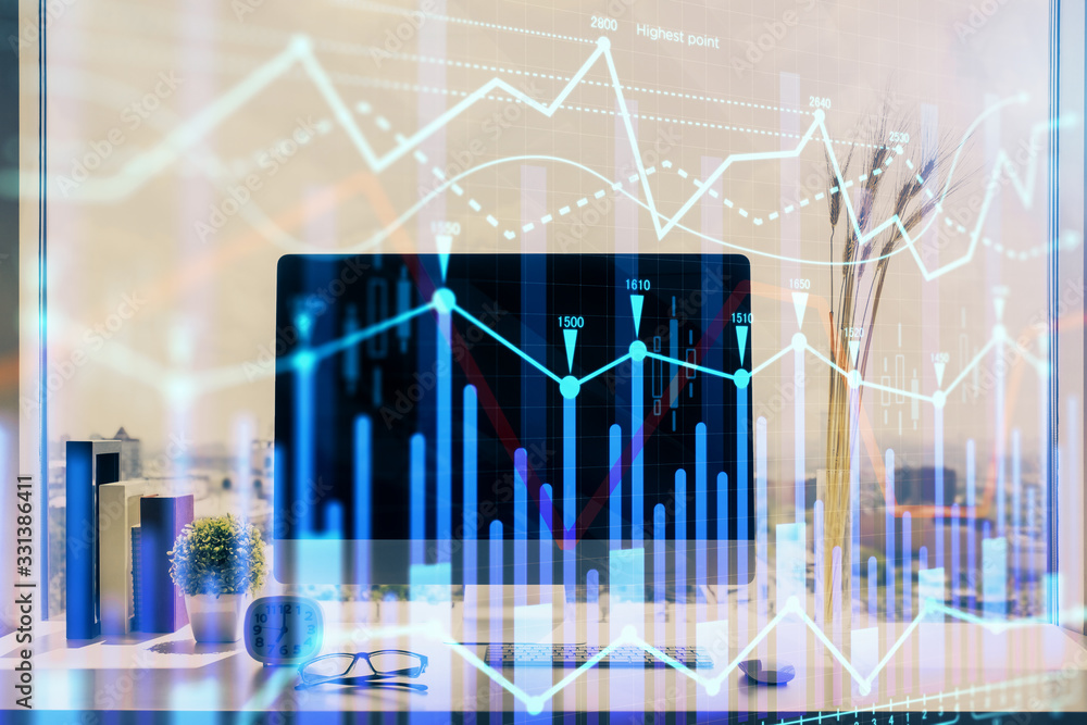 Stock market chart hologram drawn on personal computer background. Double exposure. Concept of investment. Stock market chart hologram drawn on personal computer background. Double exposure. Concept of investment.