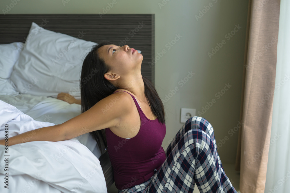 lifestyle indoors portrait of young attractive sad and depressed Asian Korean woman at home sitting on bed emotional and thoughtful feeling worried and scared about life problem lifestyle indoors portrait of young attractive sad and depressed Asian Korean woman at home sitting on bed emotional and thoughtful feeling worried and scared about life problem