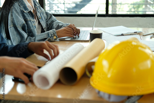 architect engineer team working discussing on house blueprint of real estate project in meeting photo