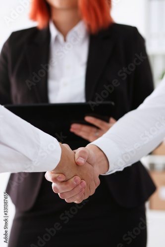 Smiling man in suit shake hands as hello in office portrait. Friend welcome mediation offer positive introduction greet or thanks gesture summit participate approval strike arm bargain concept