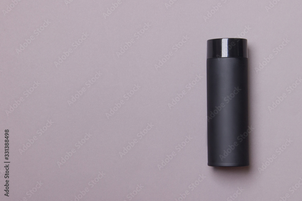 black thermos cup on grey paper background with copy space black thermos cup on grey paper background with copy space
