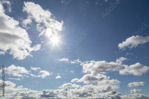 Sunny day sky landscape with cloudsand natural sun in the frame