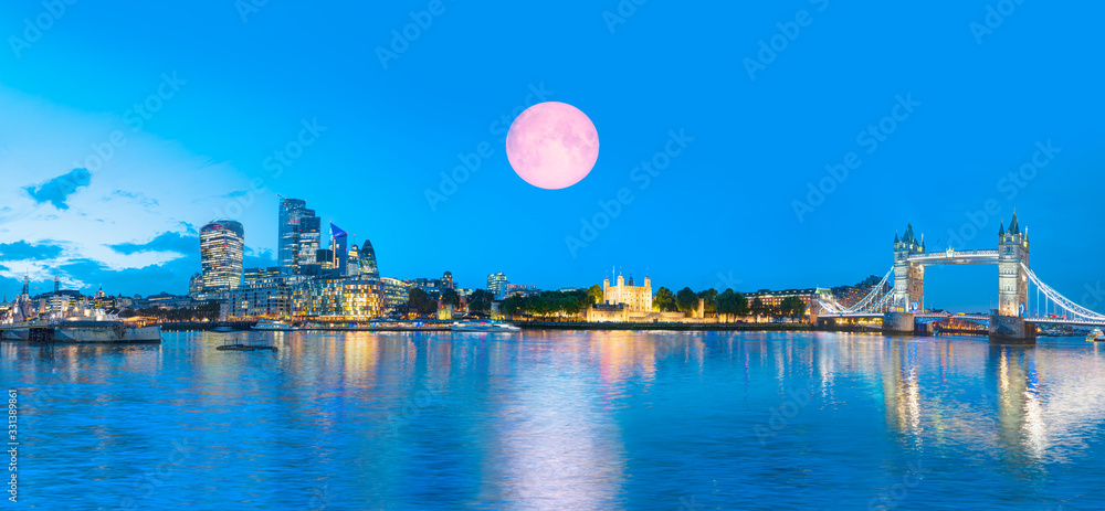 Panorama of the Tower Bridge and Tower of London on Thames river at twilight blue hour - London, United Kingdom 