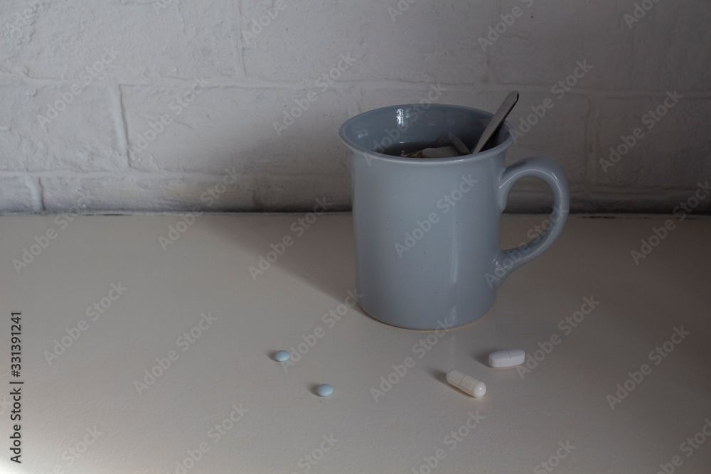 Cup and pills on the table. For patients. Quarantine Cup and pills on the table. For patients. Quarantine