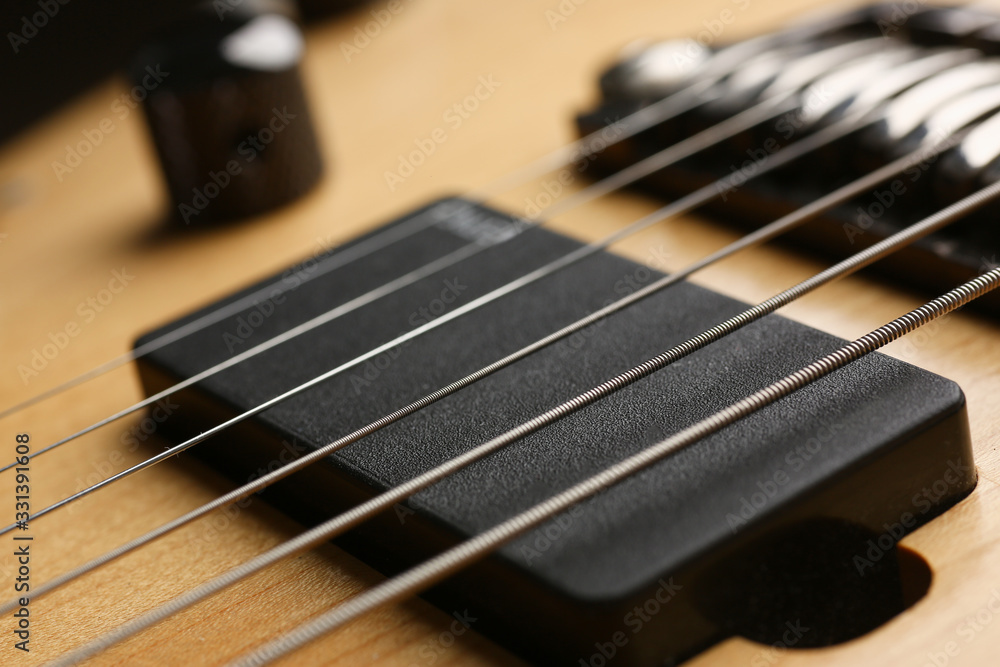 Classic shape wooden electric guitar with rosewood neck closeup. Six stringed learning lesson musician school education art leisure electrical vintage stage wood guitar concept Classic shape wooden electric guitar with rosewood neck closeup. Six stringed learning lesson musician school education art leisure electrical vintage stage wood guitar concept