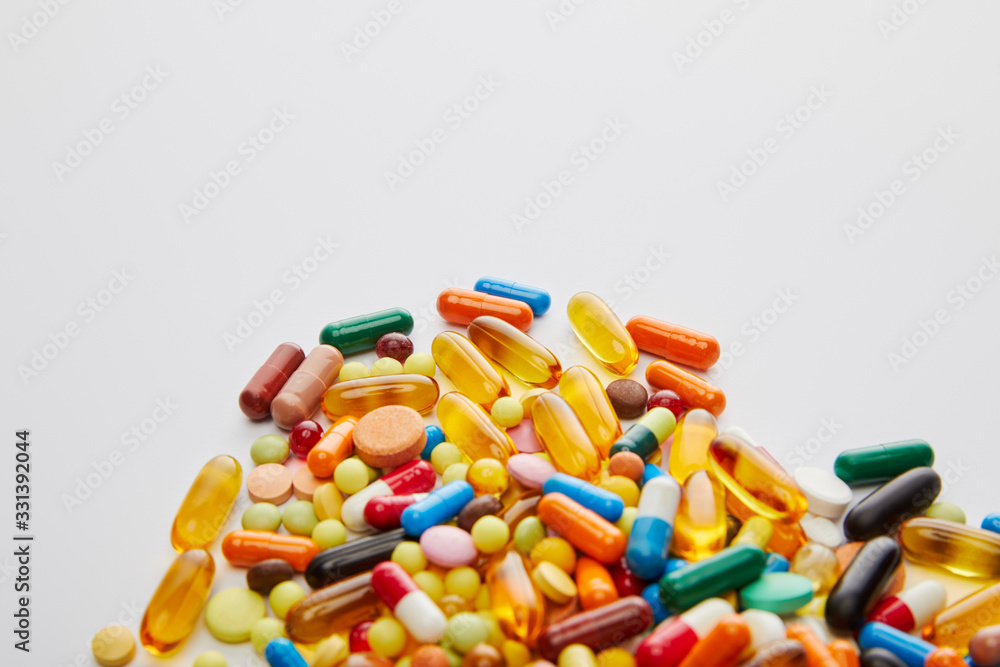 High angle view of bright capsules and pills on white background High angle view of bright capsules and pills on white background