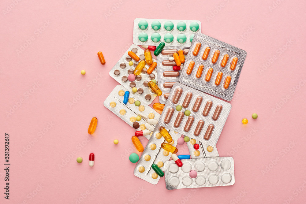 Top view of medicines on pink background Top view of medicines on pink background