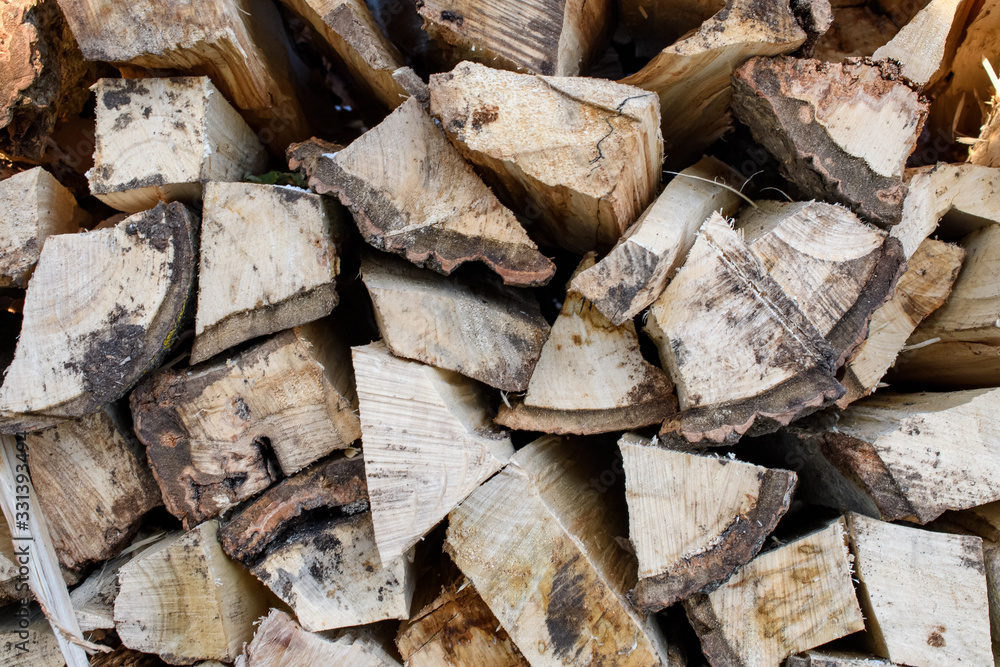 Firewood pile stacked chopped wood trunks for winter heating fireplace Firewood pile stacked chopped wood trunks for winter heating fireplace