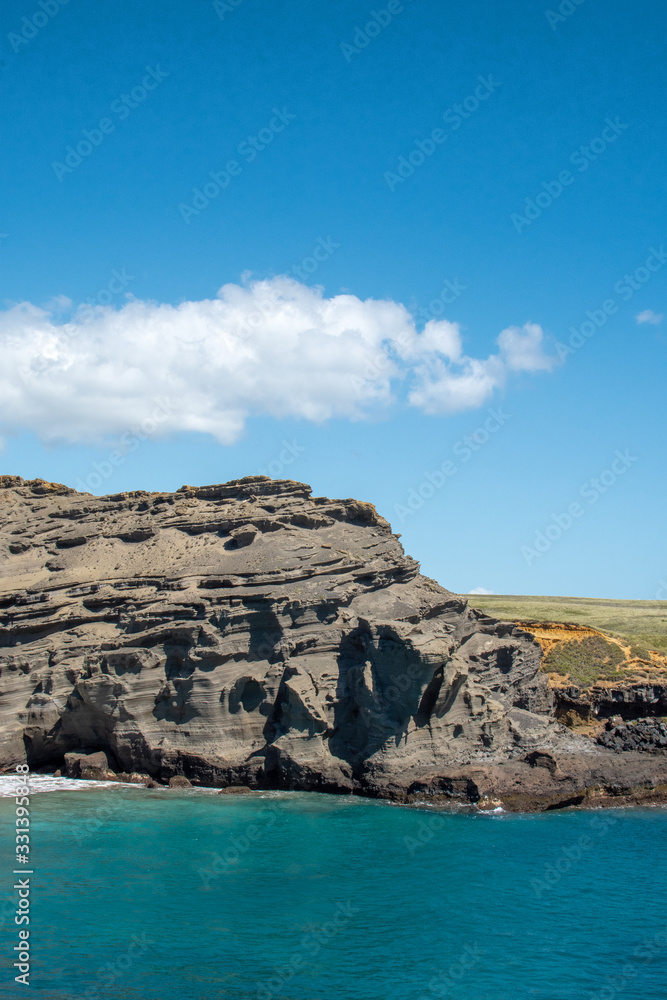 Vertical view of adjacent cliff of green sand beach in Big Island Hawaii