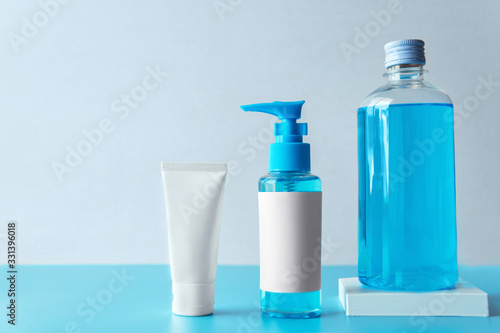 Collection of chemical blue Isopropyl alcohol (Ethanol or ethyl alcohol) liquid in a bottle for medical and prevent from germs, bacterial,coronavirus COVID-19 with blue and grey isolated background.