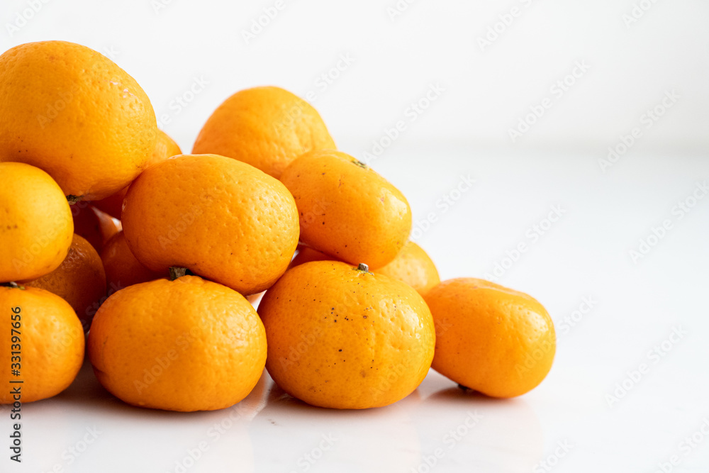 multiple orange on white marble surface. Concept for fruit nutrition and diet food. multiple orange on white marble surface. Concept for fruit nutrition and diet food.