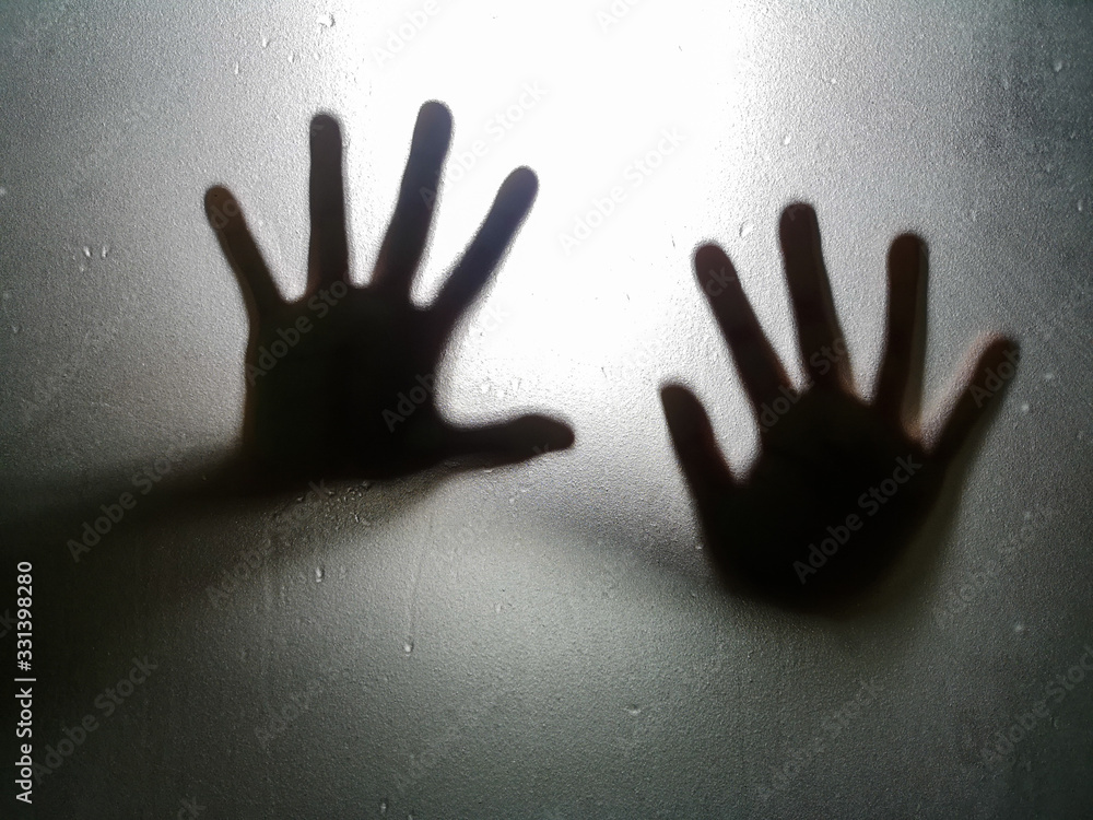 shadow of the right hand and left behind the glass is wet.