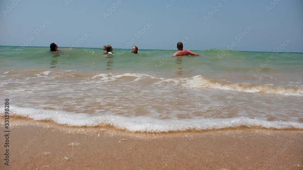 Low angle view of family enjoying holidays swimming in tropical water Low angle view of family enjoying holidays swimming in tropical water