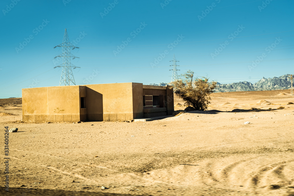 Safari in Egypt Sinai, travel of tourists in the Sahara desert.Road in the desert. Yellow sand and blue sky. Safari in Egypt Sinai, travel of tourists in the Sahara desert.Road in the desert. Yellow sand and blue sky.