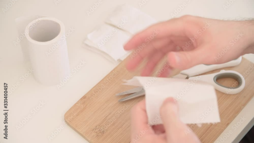 Person cut toilet paper in small pieces for shortage crisis 4K