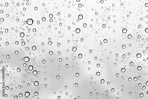 Water drops on a window glass on a winter snowy day