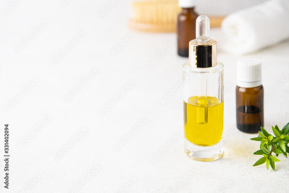 Selective focus on glass essential oil bottle, aromatherapy concept Selective focus on glass essential oil bottle, aromatherapy concept
