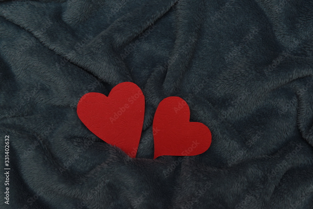 Fototapeta premium two paper hearts on a winter wool blanket