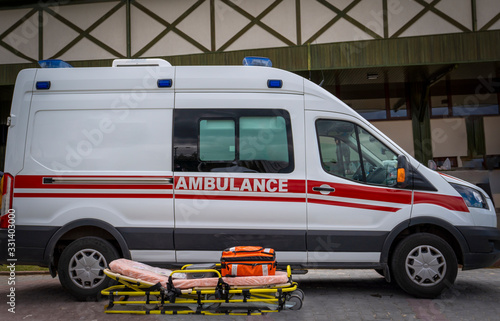 Paramedics emergency rescue team's stretcher and ambulance car is ready to help. photo